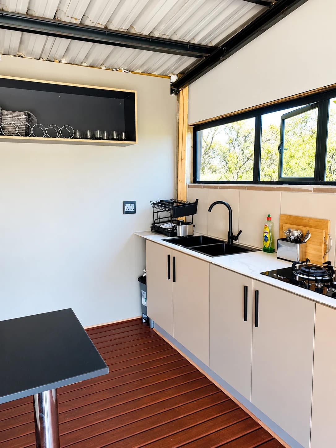 After: the kitchen with clear, cleaned countertops, photographed from a wider angle