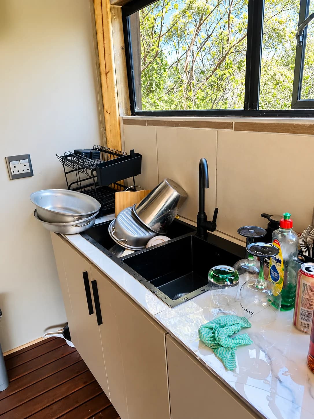 Before: dishes in the kitchen sink and items on the wet counter